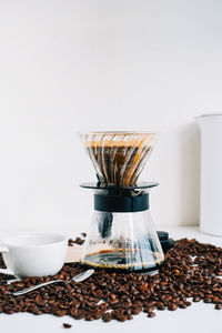 Fresh brewed coffee in a cup using alternative method, with pour over dripper and paper filter.