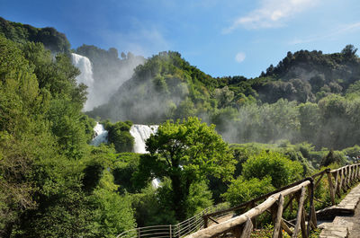 Scenic view of waterfall against sky