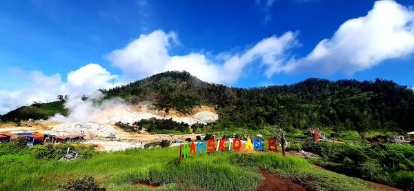 Group of people on mountain against sky