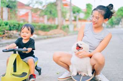 Mother and daughter sitting outdoors