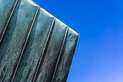 Low angle view of metallic structure against clear blue sky