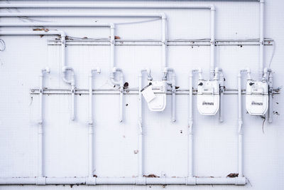 White pipes on wall in factory