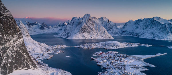 Scenic view of frozen lake against sky during winter