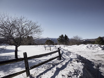 Snow covered field against sky