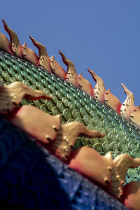 Low angle view of people against blue sky