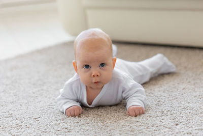 Close-up of cute baby on floor