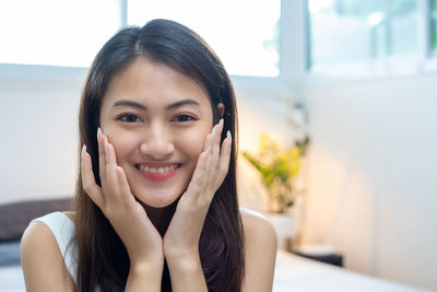 Portrait of young woman sitting at home