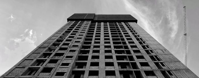 Low angle view of building against cloudy sky