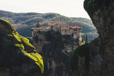 Scenic view of castle and mountains against sky