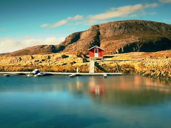 Scenic view of lake by building against sky