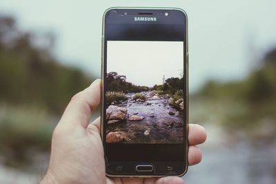 Midsection of person holding smart phone