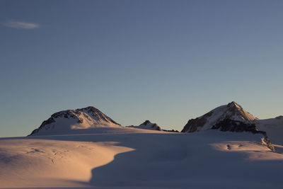 Scenic view of mountains against clear blue sky