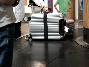Midsection of man working on table
