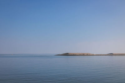 Scenic view of sea against clear blue sky