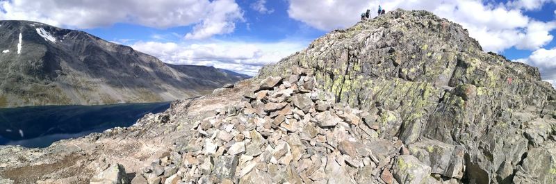 Panoramic shot of rocky mountain range against clouds