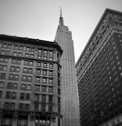 Low angle view of empire state building against sky