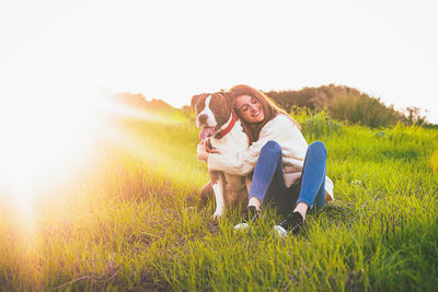 Woman with dog on field