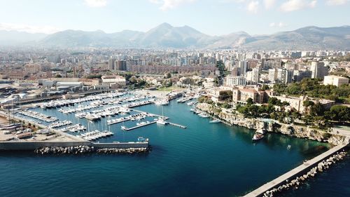High angle view of cityscape by sea against sky