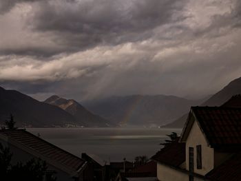 Scenic view of houses and mountains against sky