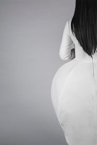 Woman standing against white background