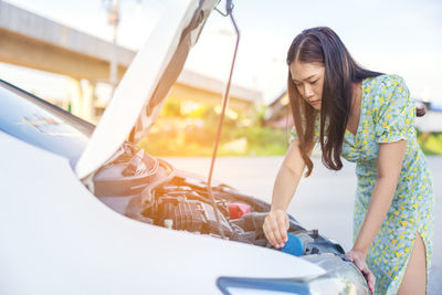 Woman looking at camera while sitting in car