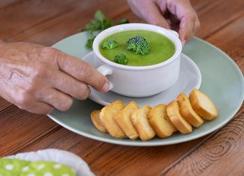 Close-up of person holding food on table