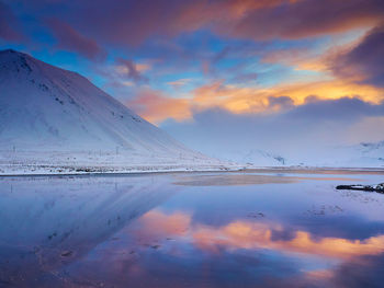 Scenic view of lake against sky during sunset