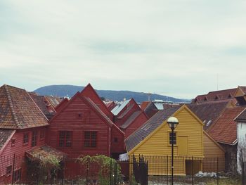 Houses against cloudy sky