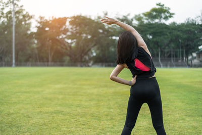 Full length of woman standing on field