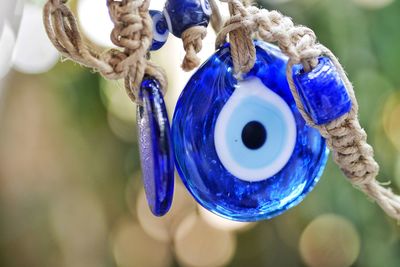 Close-up of decoration hanging against blue sky