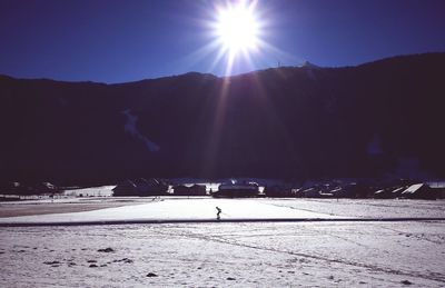 Scenic view of landscape against sky during winter