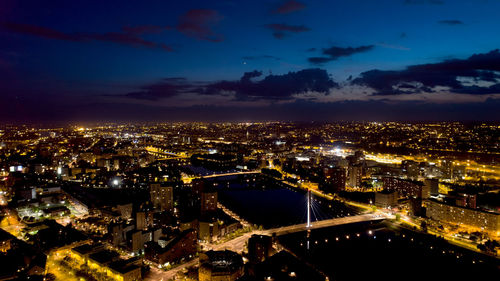 High angle view of illuminated cityscape against sky at night