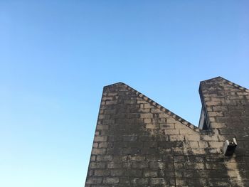 Low angle view of tower against clear blue sky