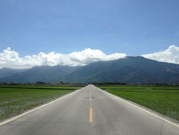 Country road with mountains in background