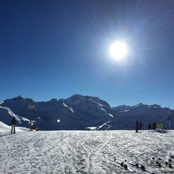 Scenic view of snow covered mountains against clear sky