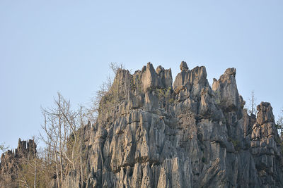 Low angle view of rock formation against clear sky