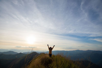 Man standing on mountain against sky