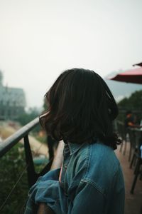 Side view of young woman standing at observation point