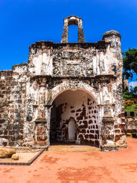 Old ruin building against blue sky