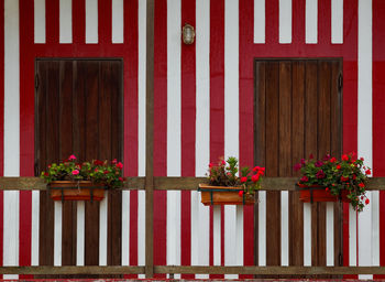 Typical colourful houses with red and white stripes in costa nova - aveiro against sky