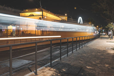 Train on railroad station platform at night