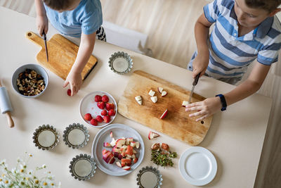 High angle view of people sitting on table