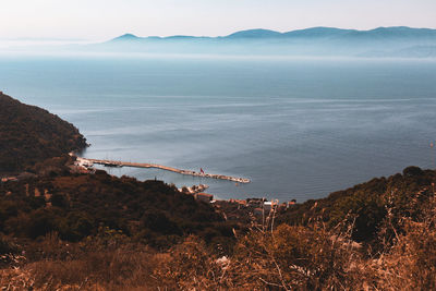 High angle view of sea and mountains against sky