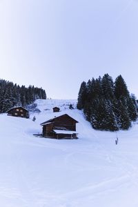 Built structure on snow covered landscape against clear sky