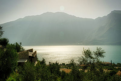 Scenic view of lake and mountains against sky