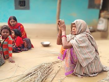 Rear view of women sitting on the floor