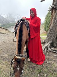Low section of woman standing on snow covered field