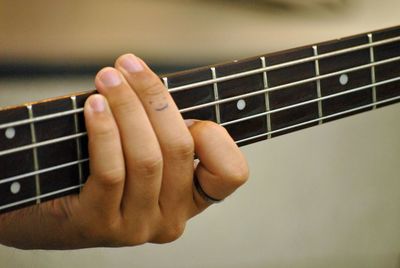 Cropped hand playing guitar