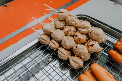 High angle view of hand on barbecue grill