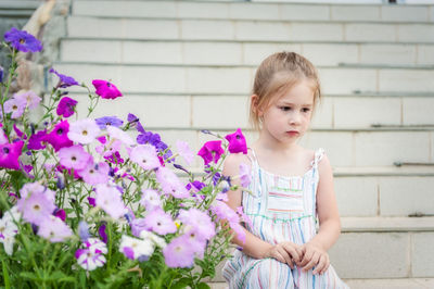 Cute girl looking at flowering plants
